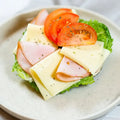 halber Bagel mit  Putenbrust, Käse, Majo, Gurke und Salat.