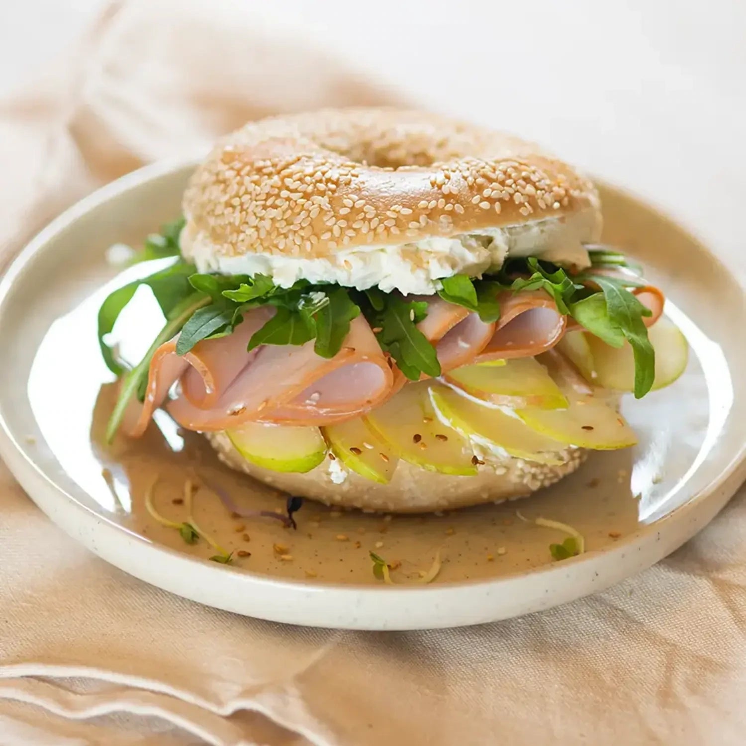 ganzer Bagel mit Frischkäse, grünem Apfel, Salat und Putenbrust.