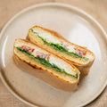 Panini -  hausgemachter Basilikum Pesto, Frischkäse, Ziegenkäse, getrocknete Tomaten und Salat.